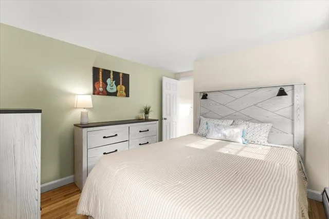 a bedroom with a bed and a night stand