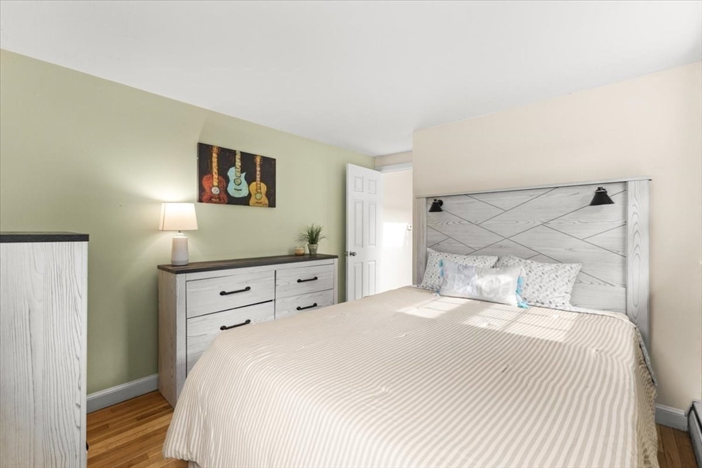 85 Maple Street Bourne, MA 02532 - Photo 23 of 42 a bedroom with a bed and a night stand