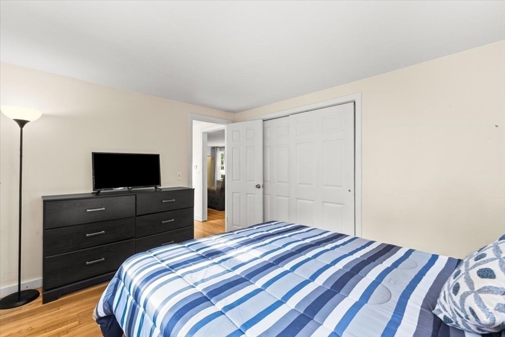 85 Maple Street Bourne, MA 02532 - Photo 25 of 42 a bedroom with a bed and a flat screen tv