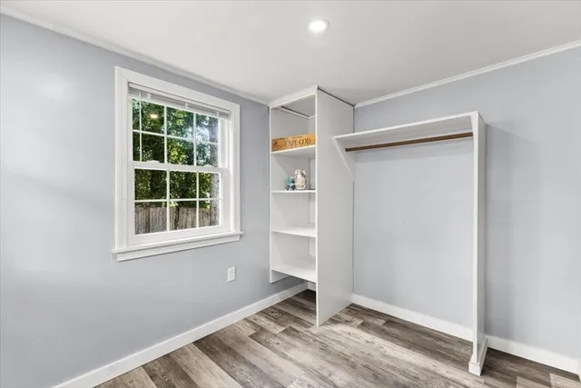 an empty room with windows and closet