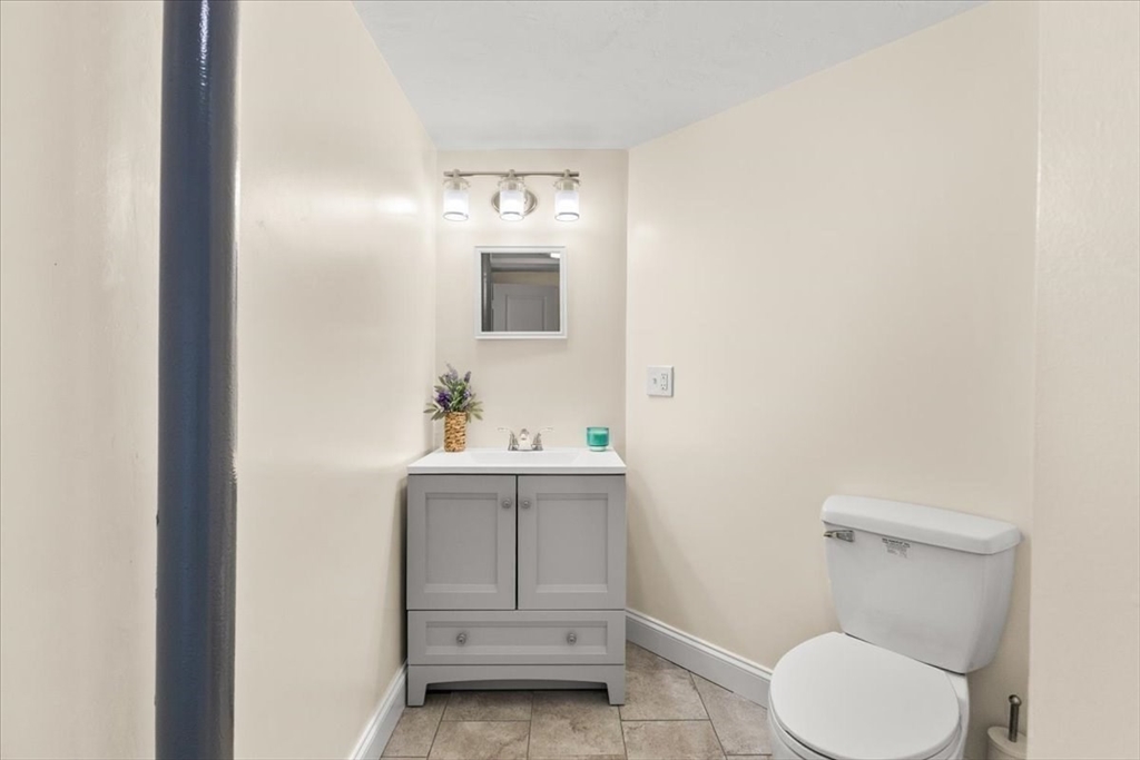 85 Maple Street Bourne, MA 02532 - Photo 30 of 42 a bathroom with a toilet sink and mirror