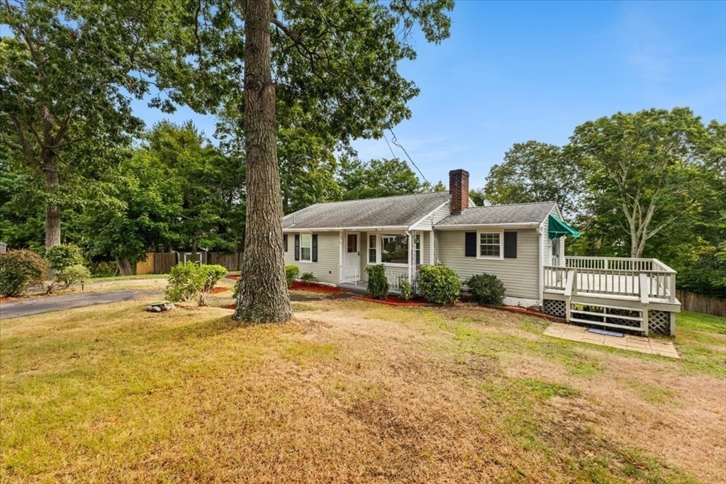 85 Maple Street Bourne, MA 02532 - Photo 3 of 42 a front view of a house with a yard table and chairs
