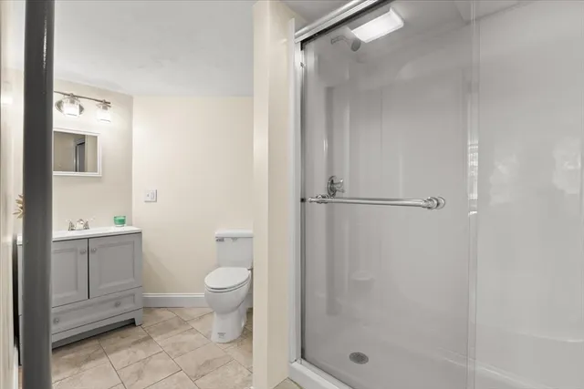 a bathroom with a shower toilet and sink