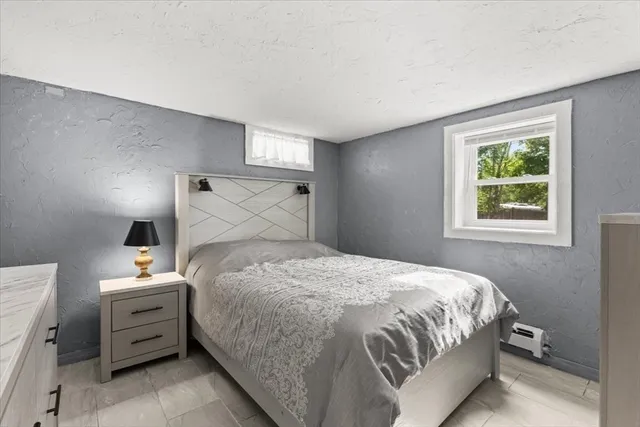 a bedroom with a bed and a window