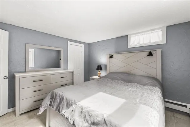 a bedroom with a large bed and a flat screen tv