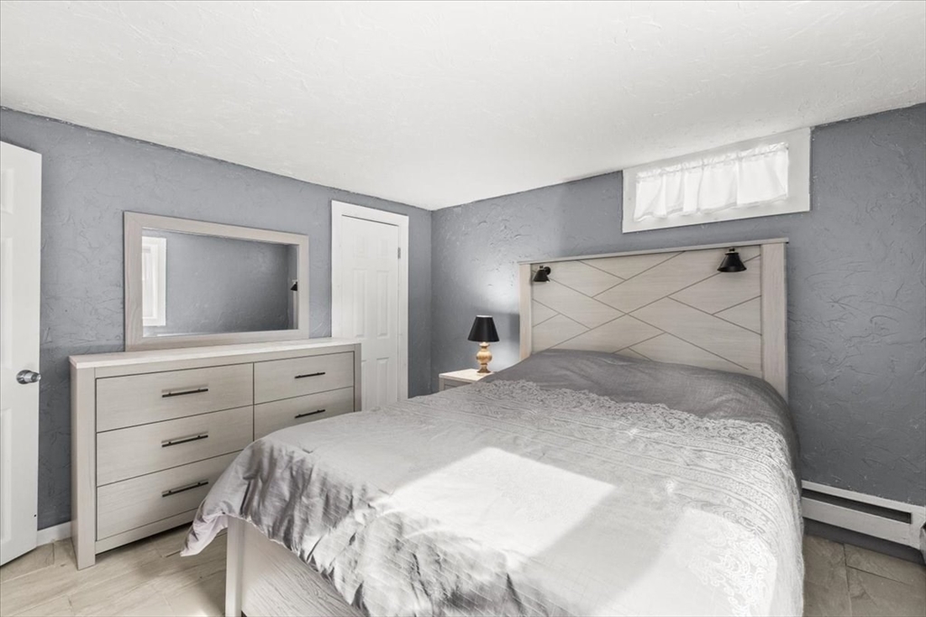 85 Maple Street Bourne, MA 02532 - Photo 33 of 42 a bedroom with a large bed and a flat screen tv