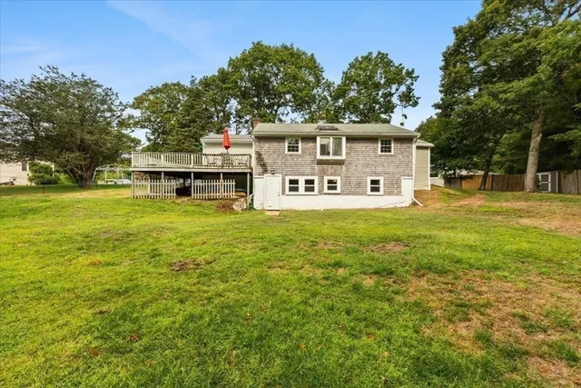 a view of a house with yard and sitting area