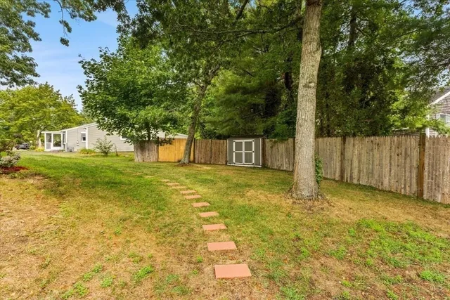 a view of a house with a backyard