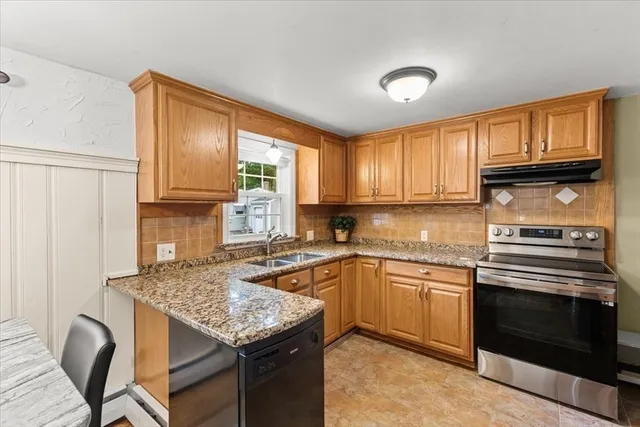 a kitchen with stainless steel appliances granite countertop a stove sink and cabinets