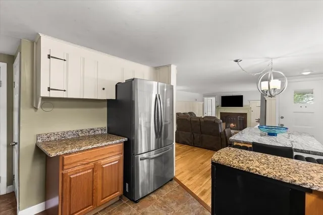 a kitchen with stainless steel appliances granite countertop a refrigerator a oven a sink a stove and a refrigerator