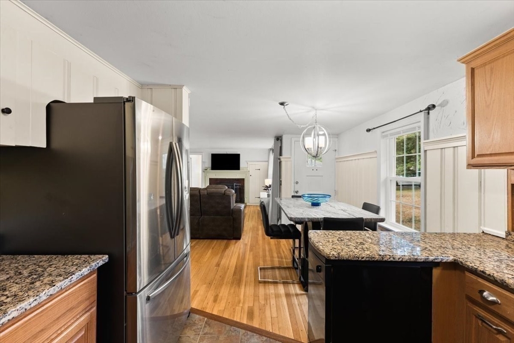 85 Maple Street Bourne, MA 02532 - Photo 8 of 42 a kitchen with granite countertop a refrigerator and a sink