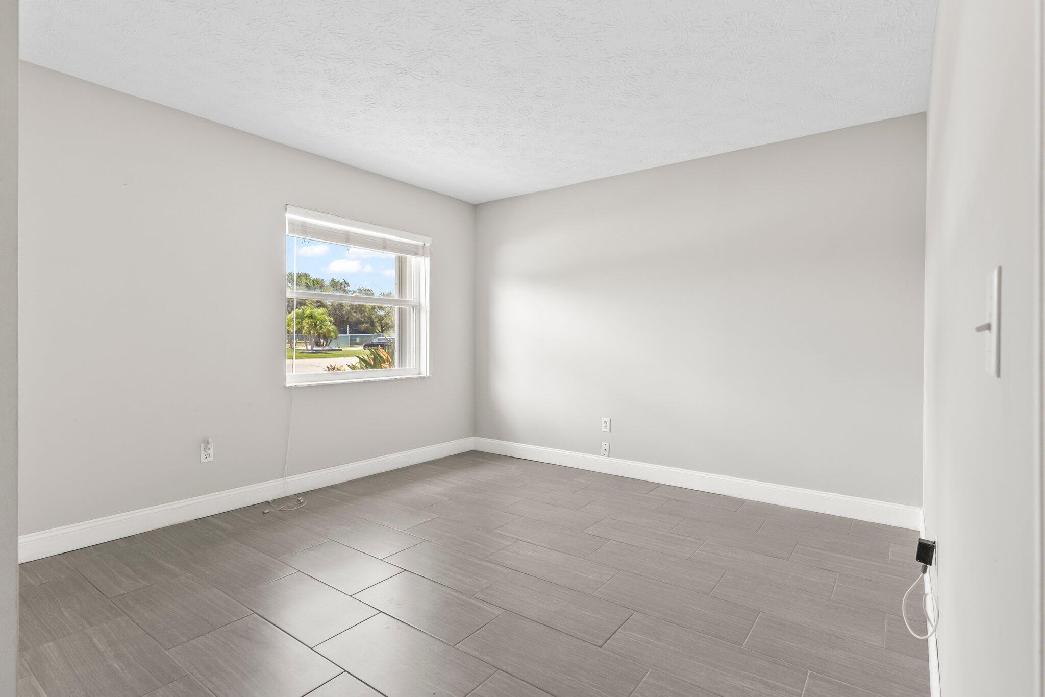 5712 Spindle Place Fort Pierce, FL 34982 - Photo 13 of 35 an empty room with windows