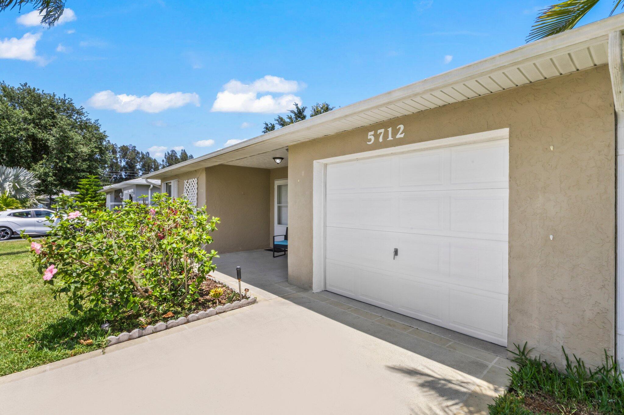 5712 Spindle Place Fort Pierce, FL 34982 - Photo 21 of 35 a front view of a house with garden