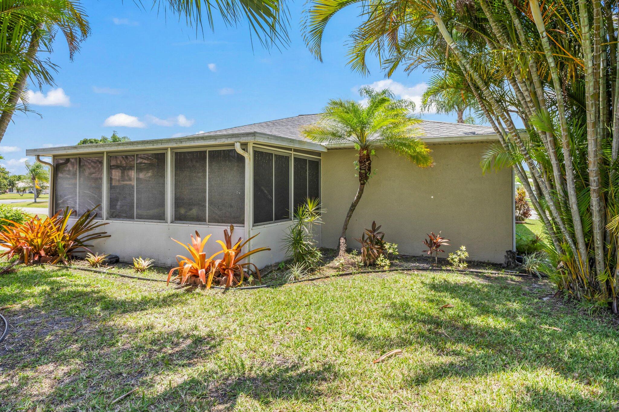 5712 Spindle Place Fort Pierce, FL 34982 - Photo 23 of 35 a front view of a house with a yard