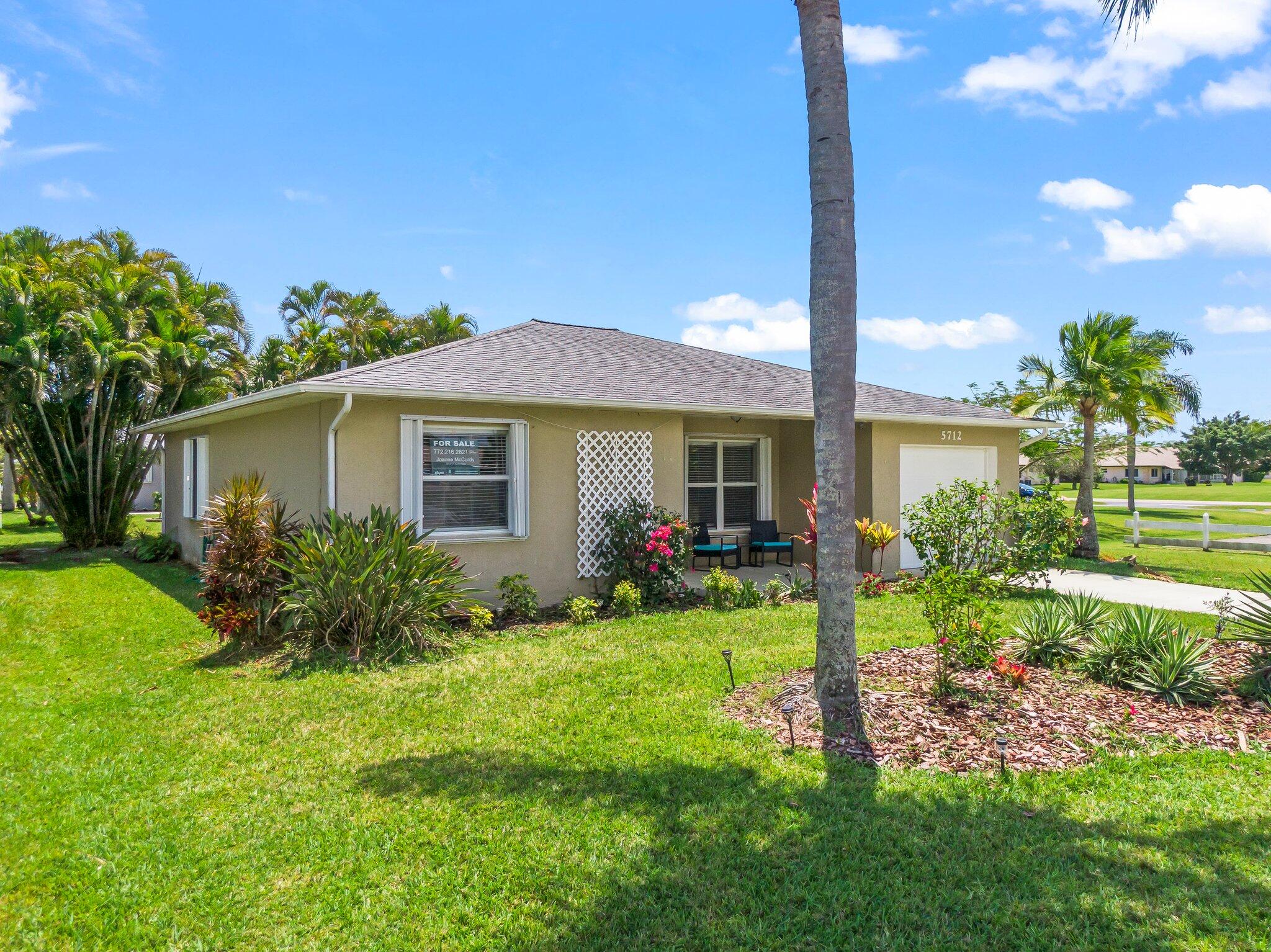 5712 Spindle Place Fort Pierce, FL 34982 - Photo 25 of 35 a view of a house with a yard and potted plants