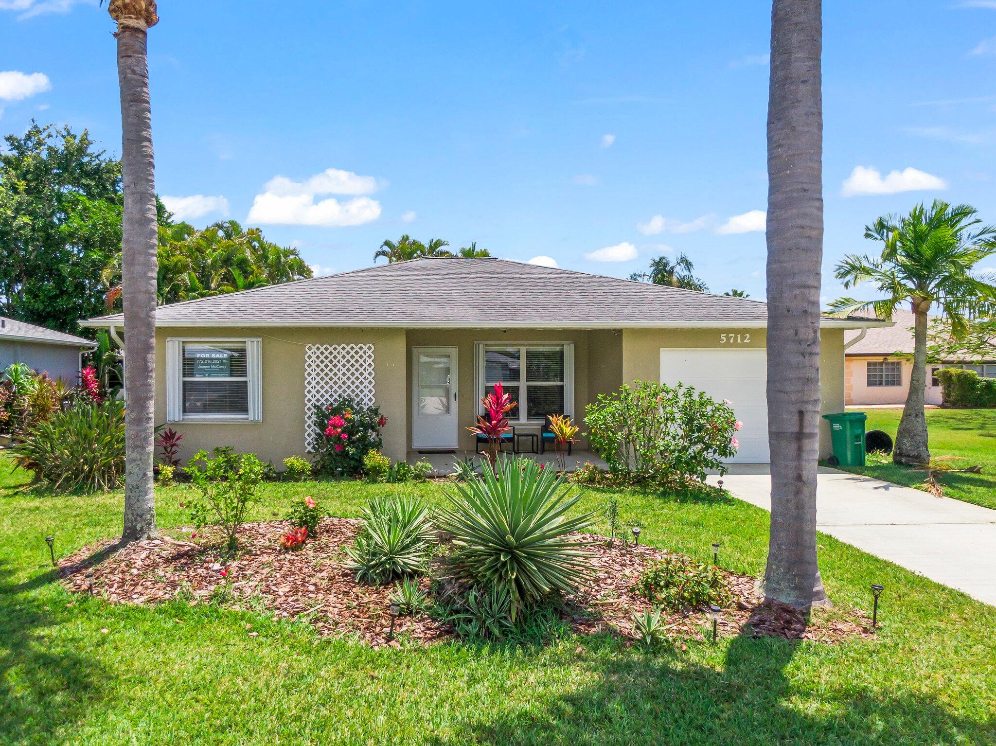 5712 Spindle Place Fort Pierce, FL 34982 - Photo 26 of 35 a view of a house with a yard and garden