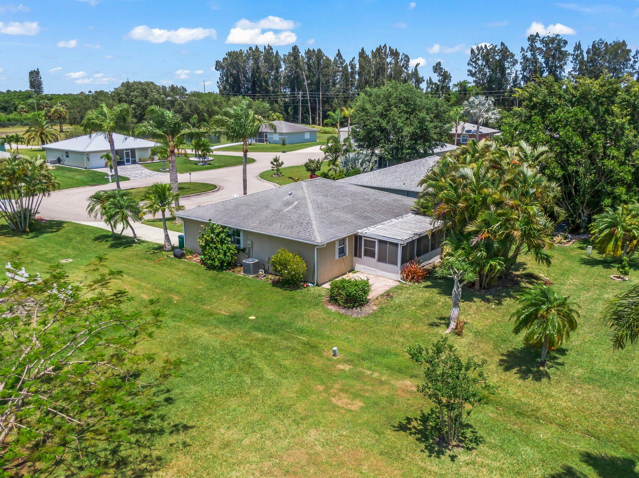 5712 Spindle Place Fort Pierce, FL 34982 - Photo 31 of 35 an aerial view of a house with yard and green space