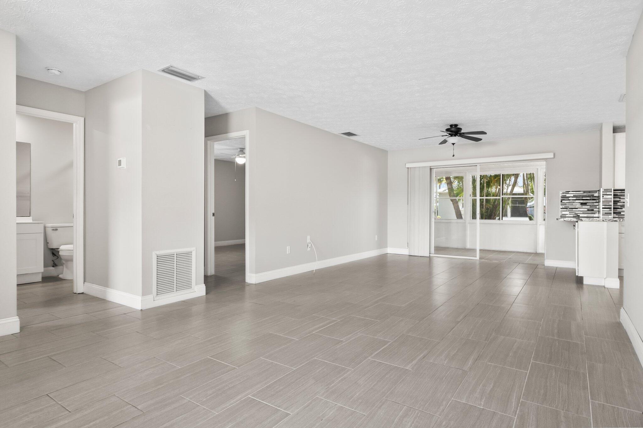 5712 Spindle Place Fort Pierce, FL 34982 - Photo 6 of 35 wooden floor in an empty room with a window