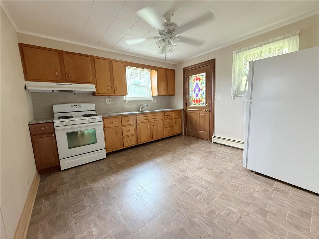 1111 Schang Road Pittsburgh, PA 15236 - Photo 2 of 12 a kitchen with granite countertop a stove a sink and a refrigerator