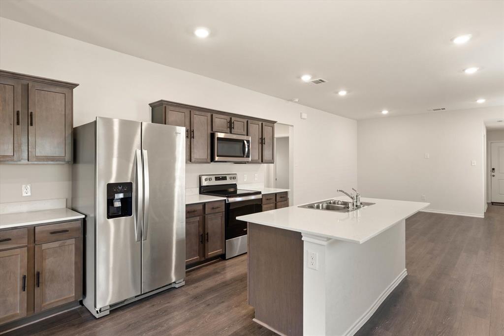3117 Pr Hl Grove Crandall, TX 75114 - Photo 4 of 16 a kitchen with stainless steel appliances a refrigerator sink and microwave