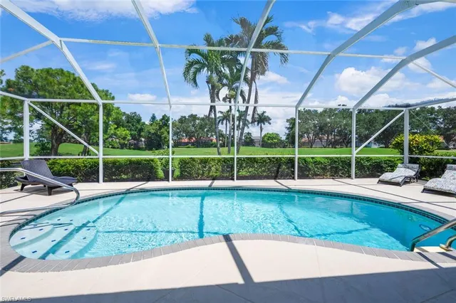 a view of a backyard with table and chairs under an umbrella