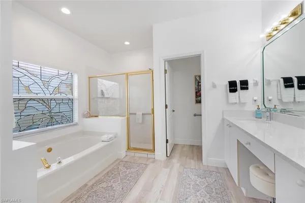 a bedroom with a bed couch and a window