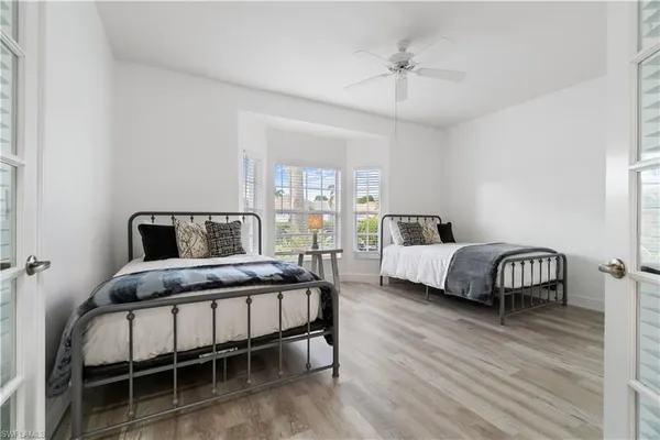 a bedroom with a bed and a lamp on table