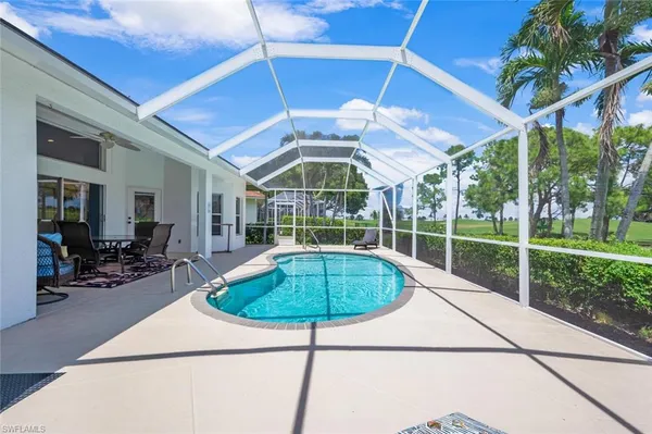 a view of a backyard with swimming pool