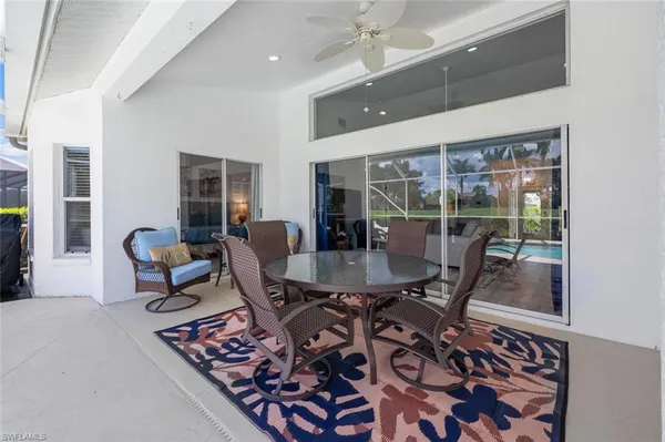 a dining room with furniture and a floor to ceiling window