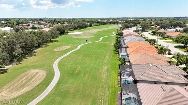 an aerial view of a house with a yard and swimming pool