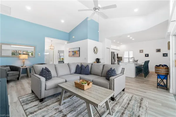 a living room with furniture and wooden floor