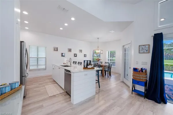 a kitchen with stainless steel appliances lots of counter top space and furniture