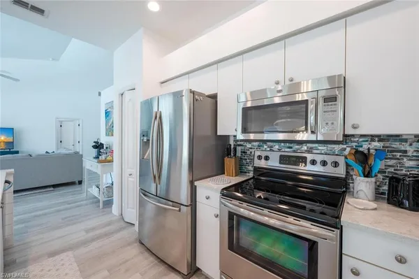 an aerial view of a houses with a swimming pool