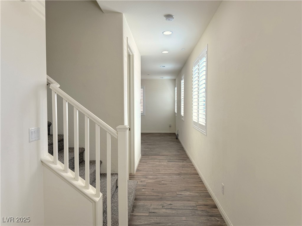 340 Mezzaforte Street Henderson, NV 89011 - Photo 3 of 39 Corridor featuring wood finished floors, stairway, and recessed lighting