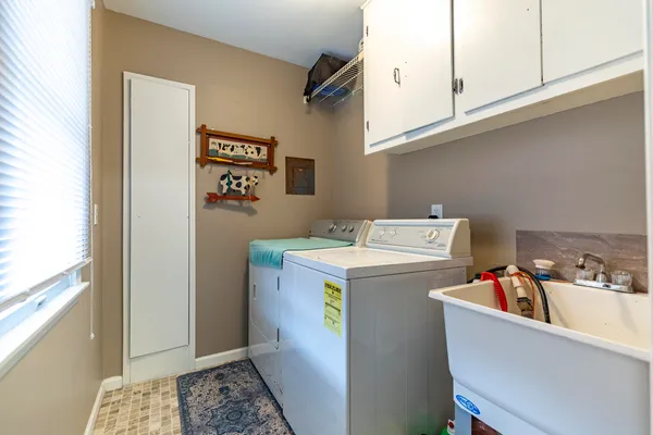 a kitchen with window cabinets and white appliances