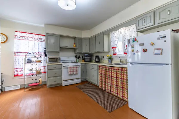 a dining room with furniture and wooden floor