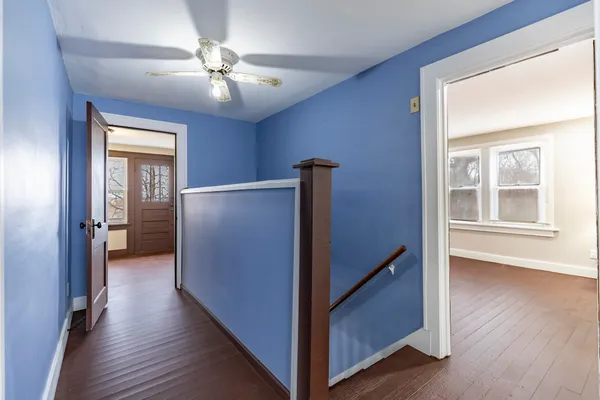 an empty room with windows closet and fireplace