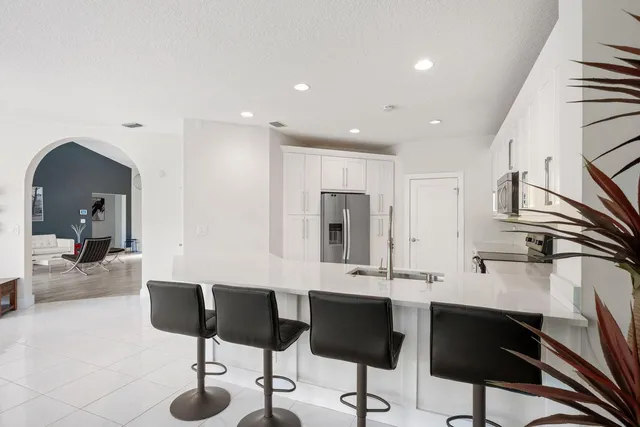 a kitchen with stainless steel appliances kitchen island granite countertop a sink and cabinets