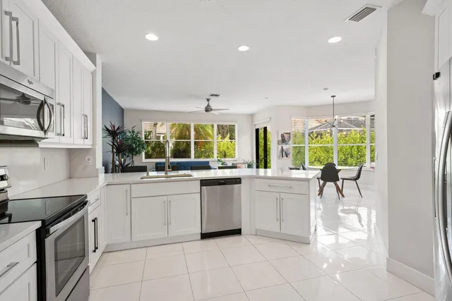 a kitchen with stainless steel appliances granite countertop a stove and a sink