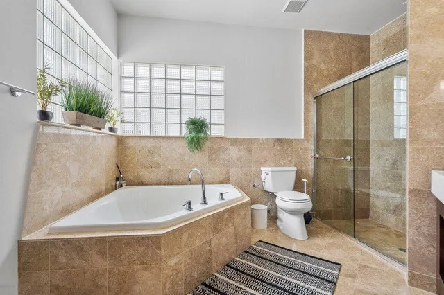 a bathroom with a white bath tub and a shower