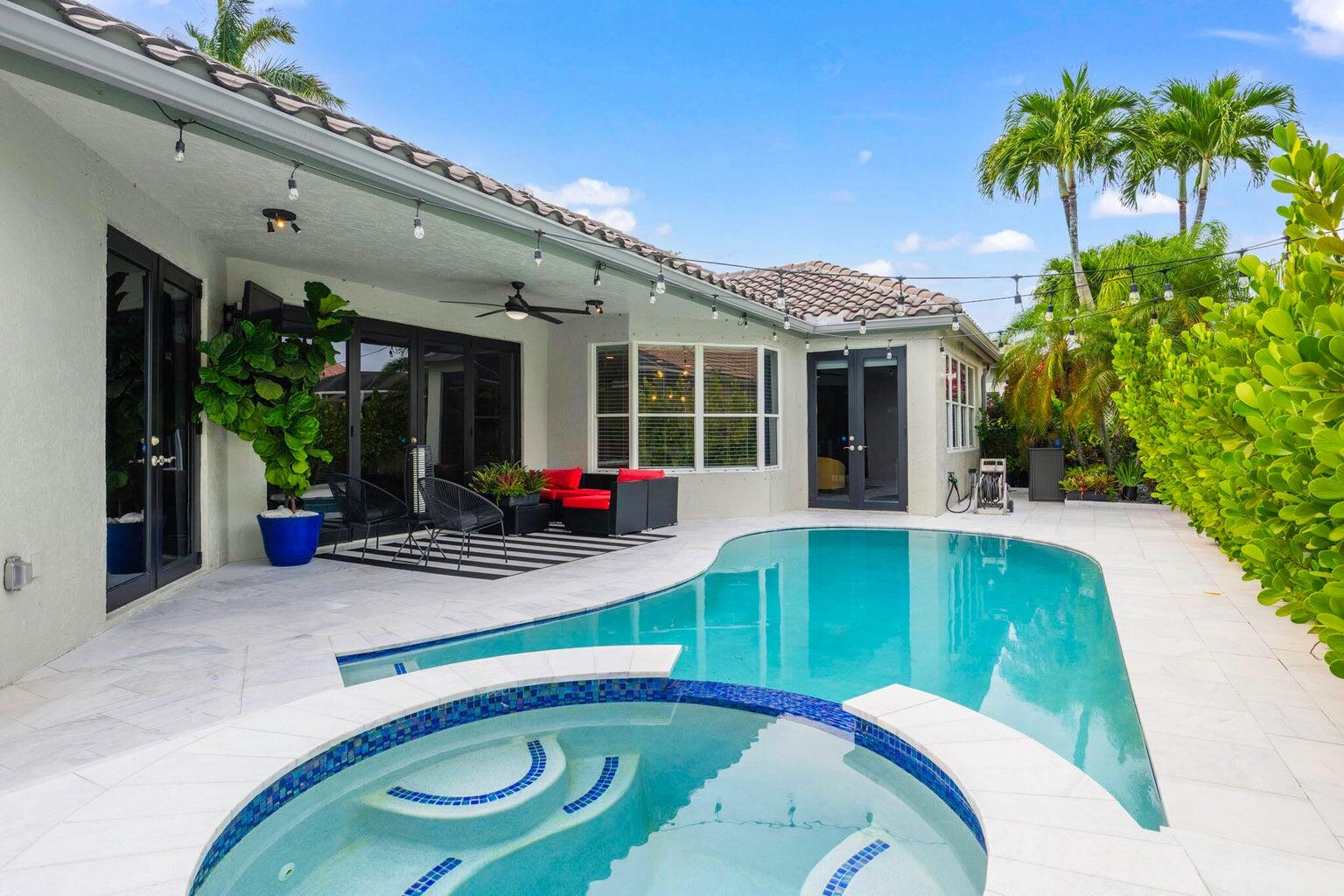 10982 Ravel Court Boca Raton, FL 33498 - Photo 29 of 44 a swimming pool with outdoor seating and yard