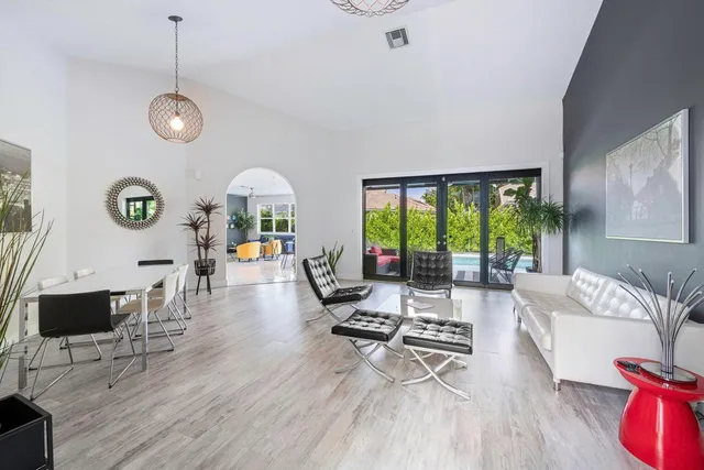 a living room with furniture a window and a chandelier