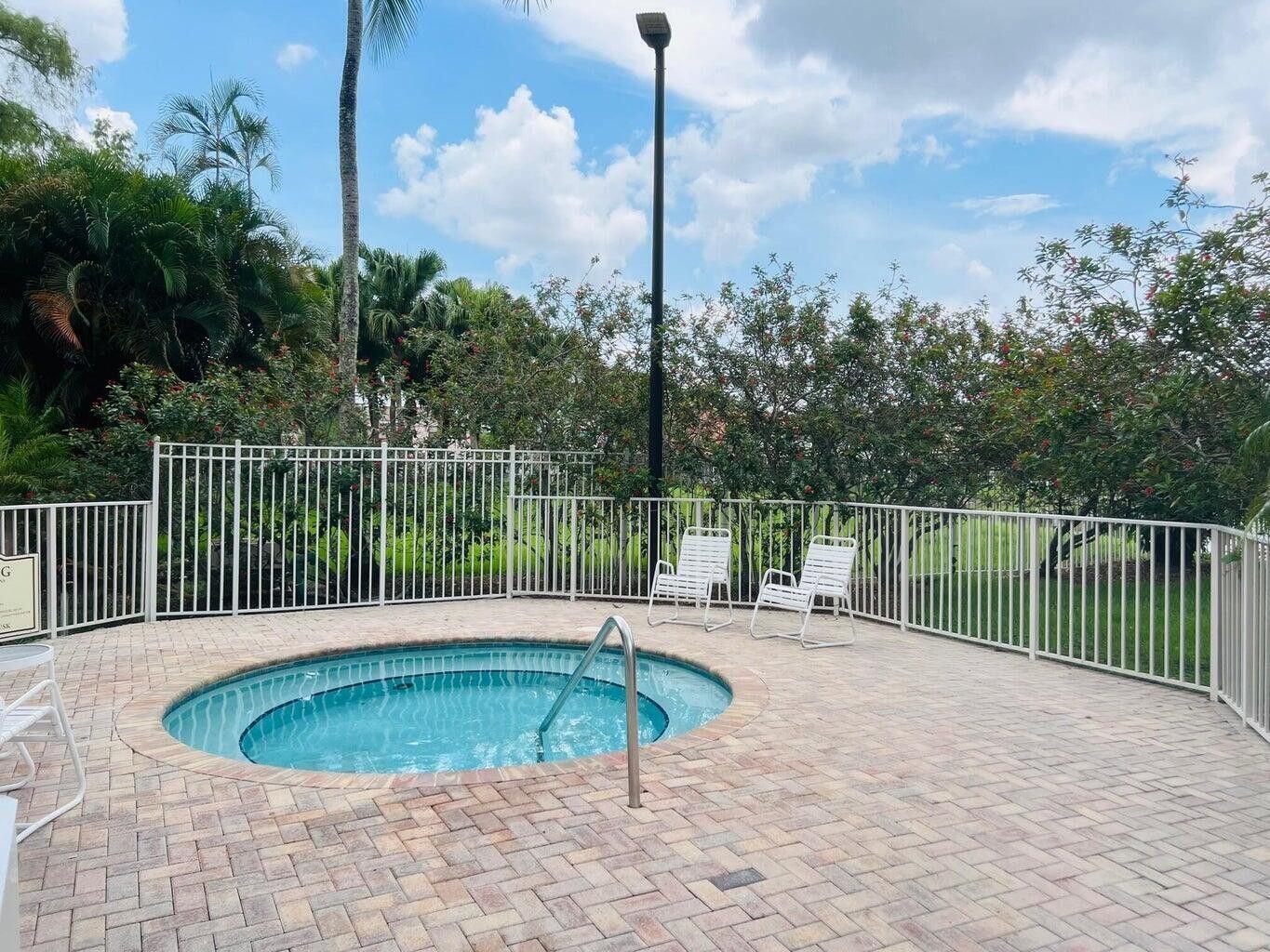 10982 Ravel Court Boca Raton, FL 33498 - Photo 32 of 44 a view of a swimming pool with a patio
