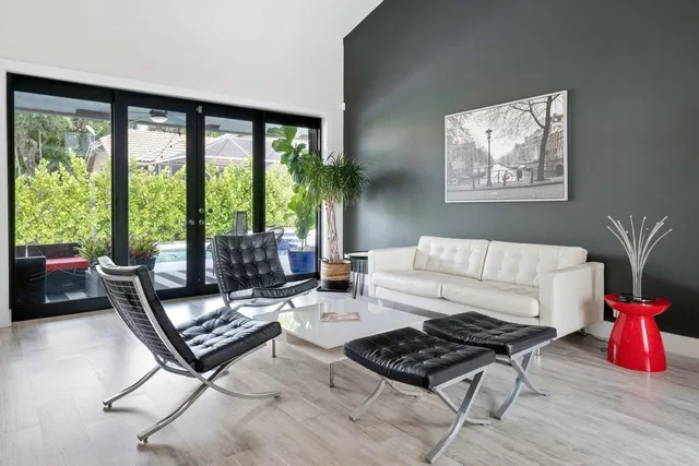 a living room with furniture and a floor to ceiling window