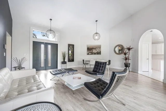 a living room with furniture and wooden floor