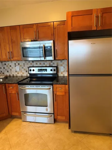 a stove top oven sitting inside of a kitchen
