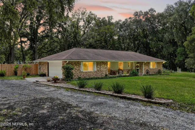 a kitchen with kitchen island granite countertop a sink counter top space appliances and cabinets
