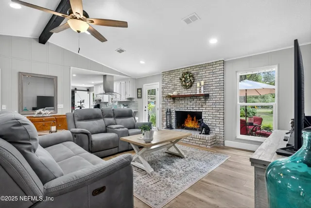 a bathroom with a granite countertop sink a mirror and shower