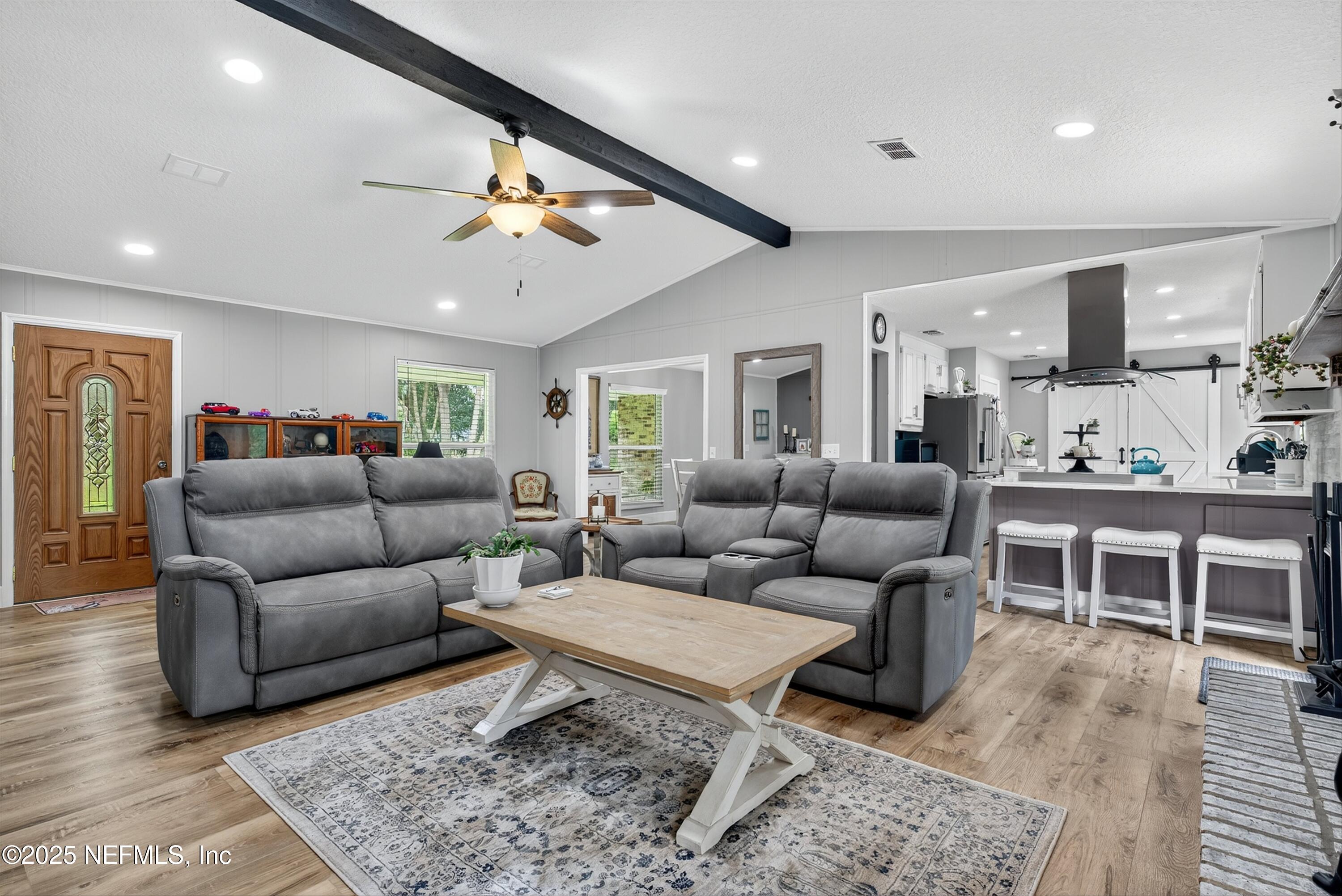 6049 Taylor Road Jacksonville, FL 32234 - Photo 18 of 60 a living room with furniture kitchen view and a wooden floor