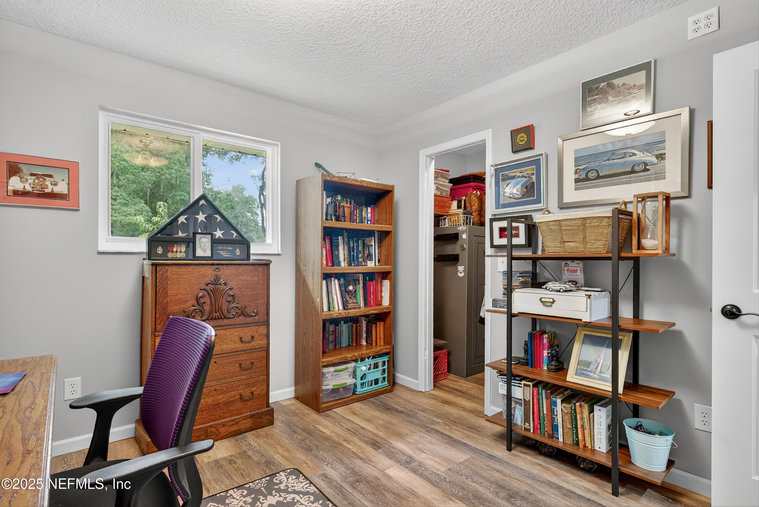 6049 Taylor Road Jacksonville, FL 32234 - Photo 41 of 60 a view of a workspace with bookshelf and a window
